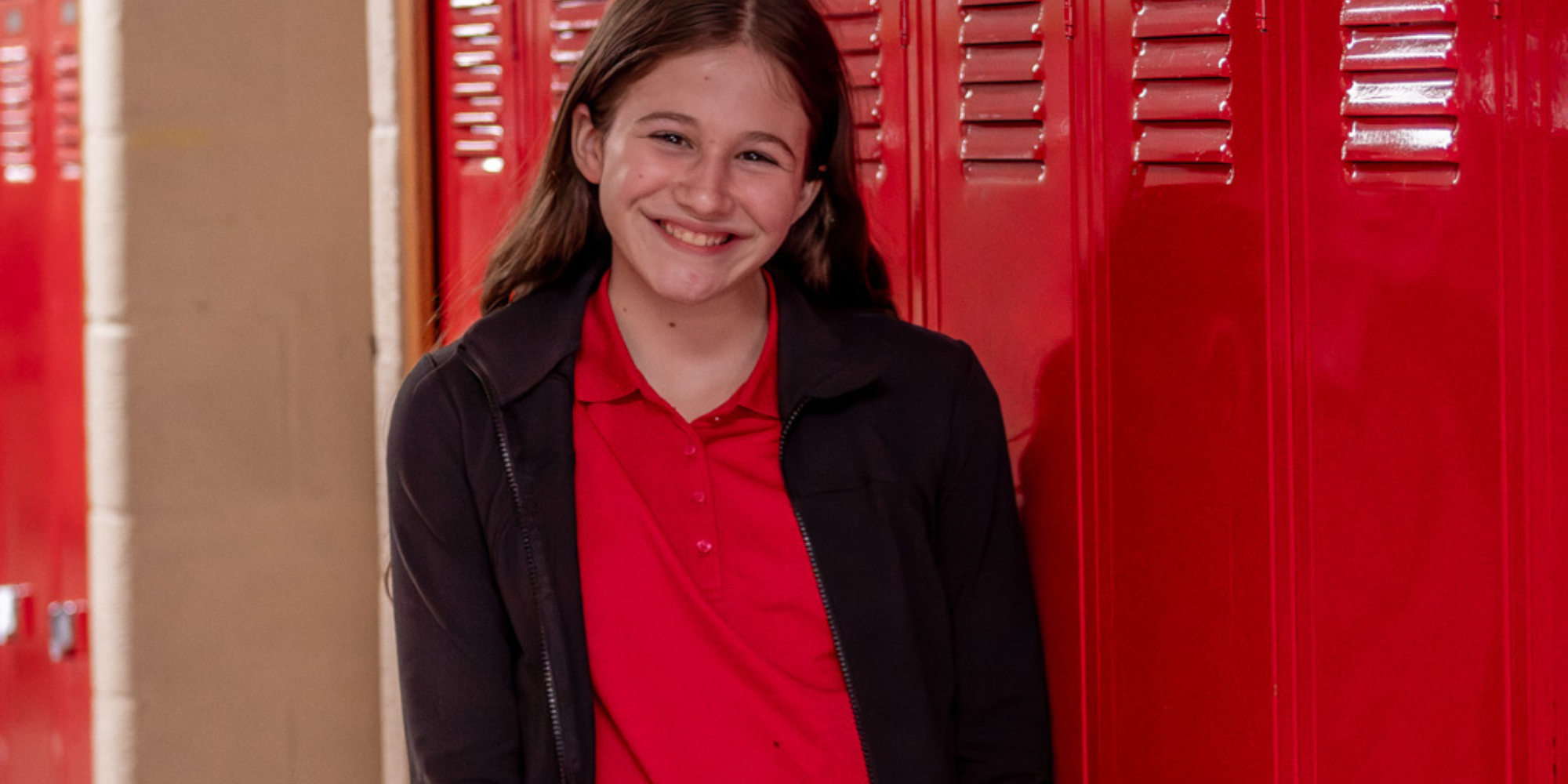 Girl standing in front of lockers